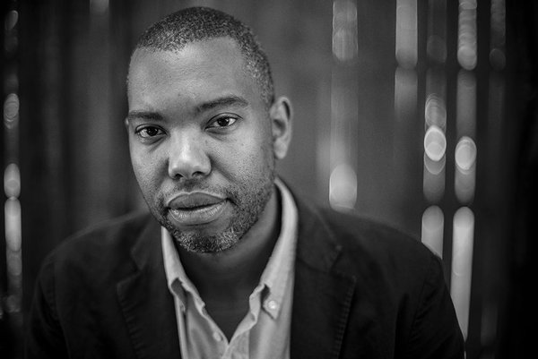 A black & white portrait of an African American man with closely cropped hair and beard.